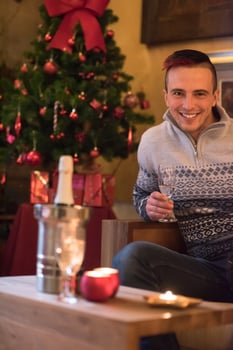 Happy young man with a glass of champagne photo