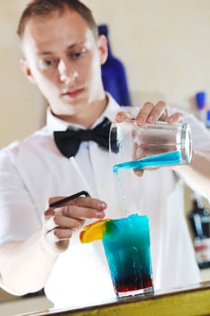 pro barman prepare coctail drink on party photo
