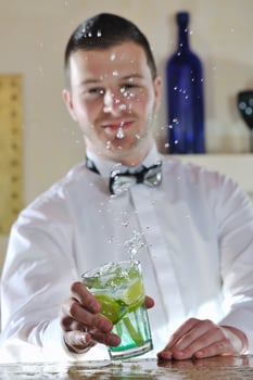 pro barman prepare coctail drink on party photo