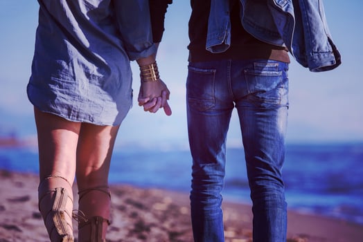 Loving young couple on a beach at autumn sunny day photo