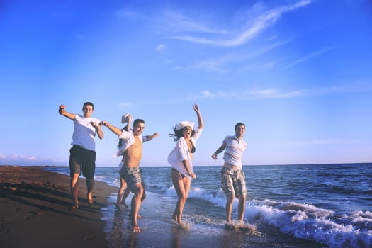 people group running on the beach photo