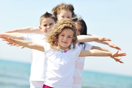 happy child group playing  on beach photo