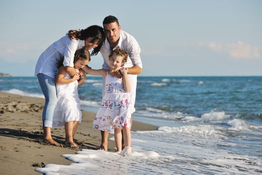 happy young  family have fun on beach photo