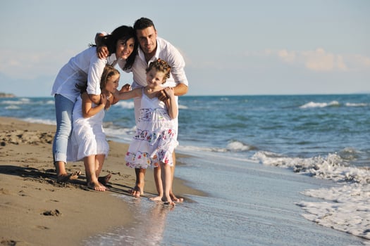 happy young  family have fun on beach photo