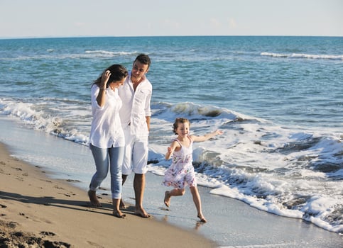 happy young  family have fun on beach photo