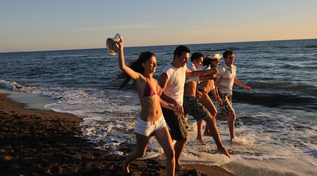 people group running on the beach photo