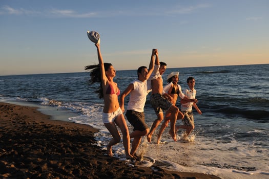 people group running on the beach photo