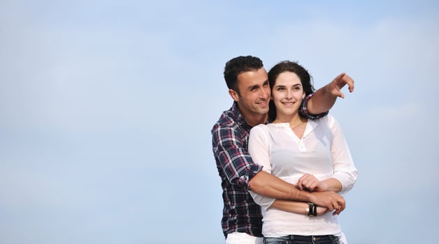 happy young couple have fun on beach photo