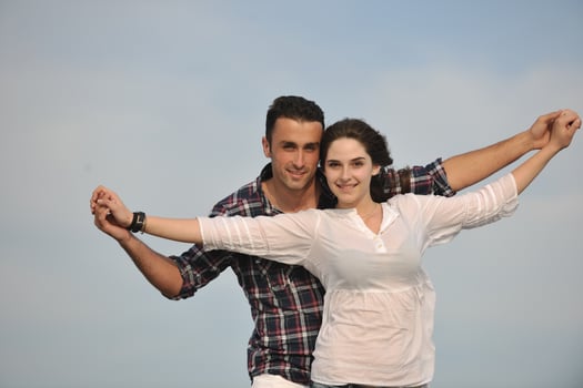 happy young couple have fun on beach photo