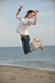 happy young couple have fun on beach photo