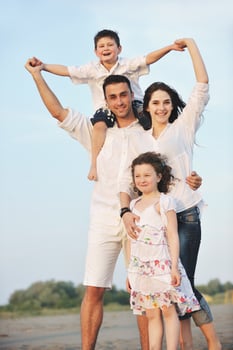 happy young family have fun on beach photo