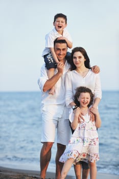 happy young family have fun on beach photo