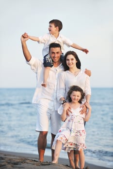 happy young family have fun on beach photo