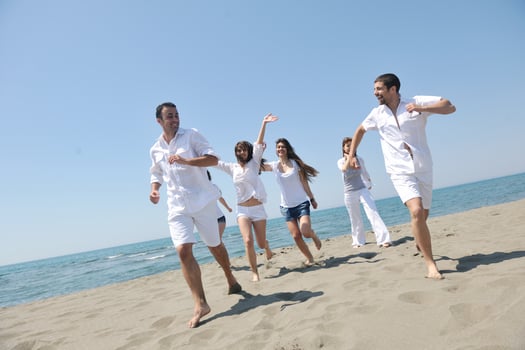 happy people group have fun and running on beach photo