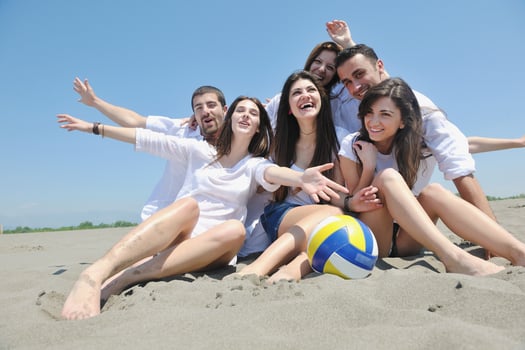 happy young  people group have fun on beach photo