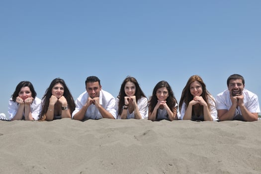 Group of happy young people in have fun at beach photo