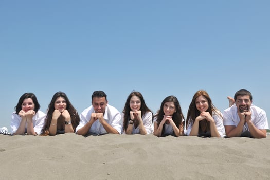 Group of happy young people in have fun at beach photo