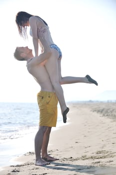 happy young couple have romantic time on beach photo