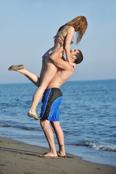 happy young couple have romantic time on beach photo