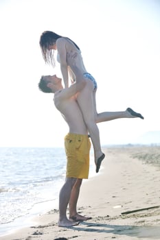 happy young couple have romantic time on beach photo