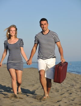 couple on beach with travel bag photo