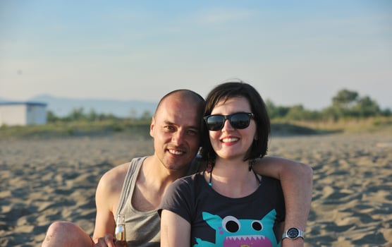 happy young couple have fun on beach photo