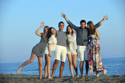happy young  people group have fun on beach photo