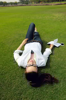 Young woman reading a book in the park photo