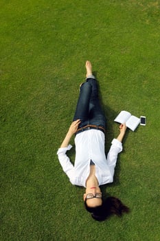 Young woman reading a book in the park photo