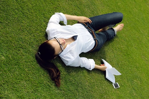 Young woman reading a book in the park photo
