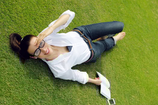 Young woman reading a book in the park photo