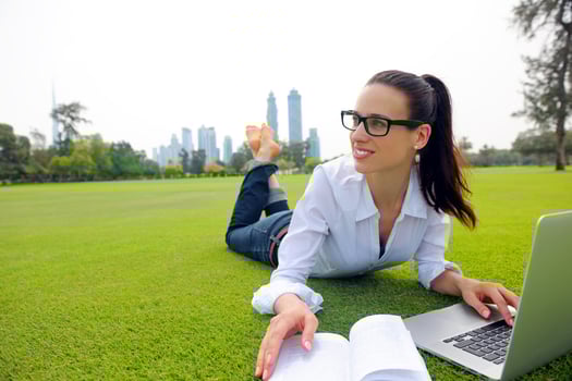 woman with laptop in park photo