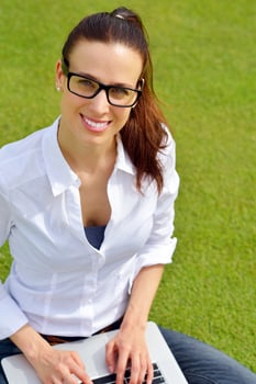 woman with laptop in park photo