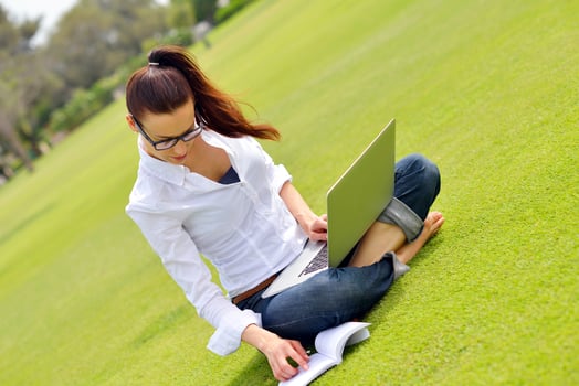 woman with laptop in park photo