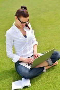 woman with laptop in park photo