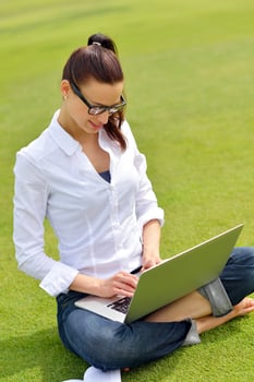 woman with laptop in park photo