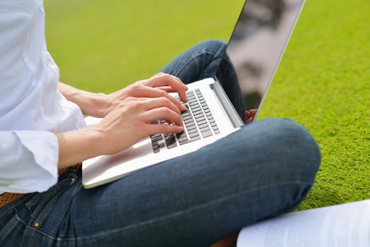 woman with laptop in park photo