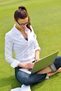 woman with laptop in park photo