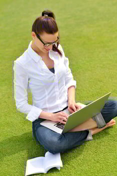 woman with laptop in park photo