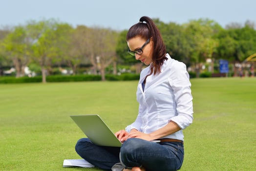 woman with laptop in park photo
