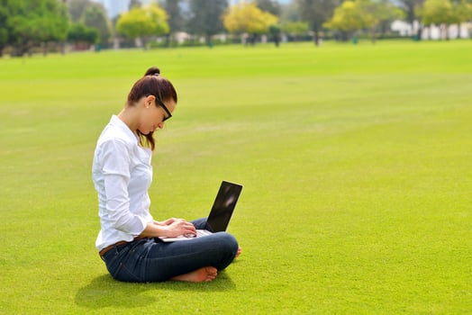 woman with laptop in park photo