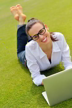 woman with laptop in park photo