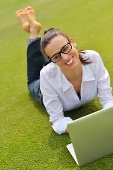woman with laptop in park photo
