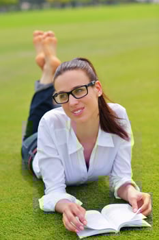 Young woman reading a book in the park photo