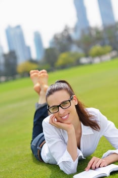 Young woman reading a book in the park photo