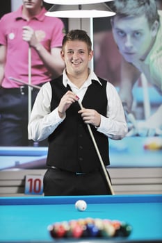 young man play pro billiard game photo