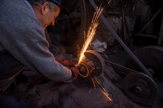 the blacksmith polishing metal products photo