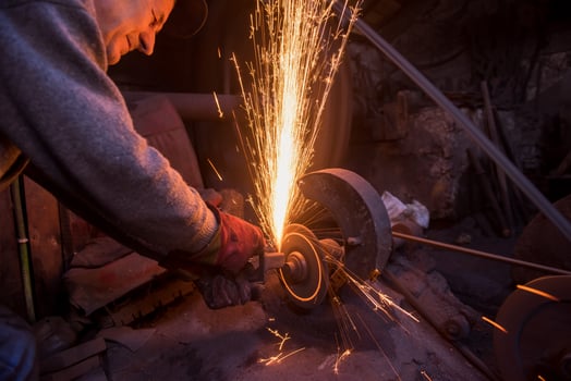 the blacksmith polishing metal products photo