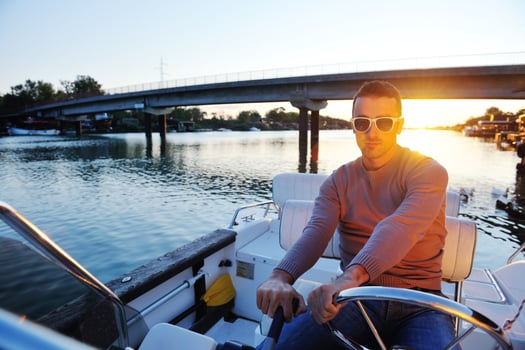 portrait of happy young man on boat photo