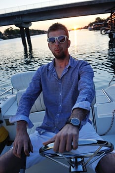 portrait of happy young man on boat photo